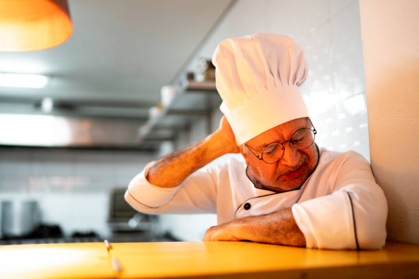 istock A tired / worried senior chef in the kitchen counter 1192271084