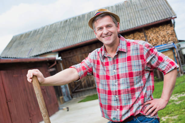 istock Mature farmer standing in farm 1192273352