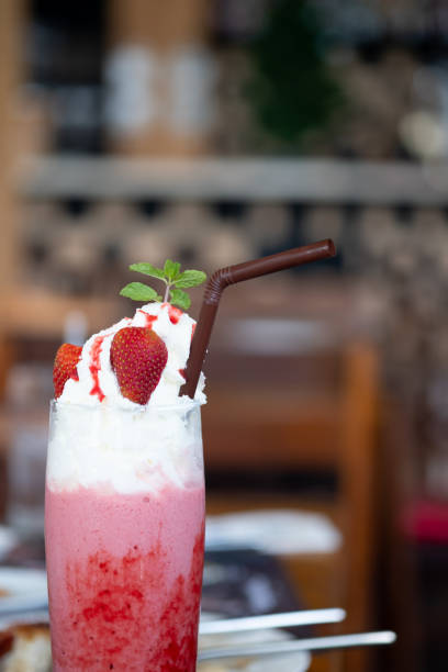 istock Strawberry pink milkshake with whipped cream, side view 1192274023