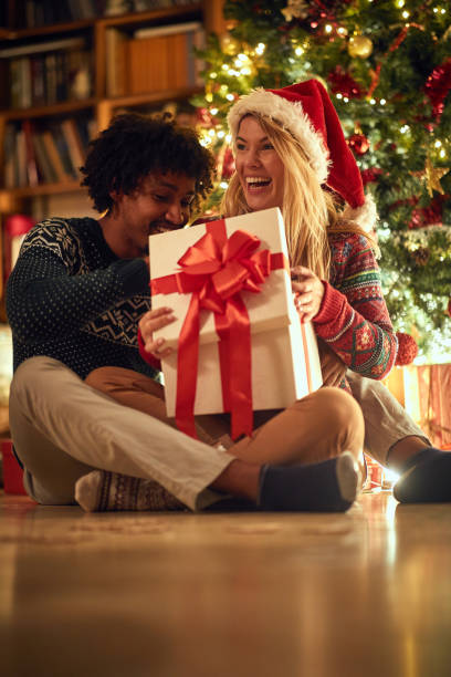 istock Christmas presents. Couple  exchanging Christmas gift 1192274221