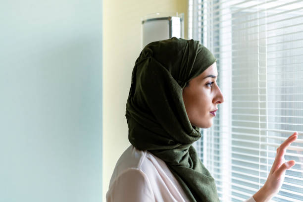 istock Woman with Hijab Standing Next to Window 1192275209