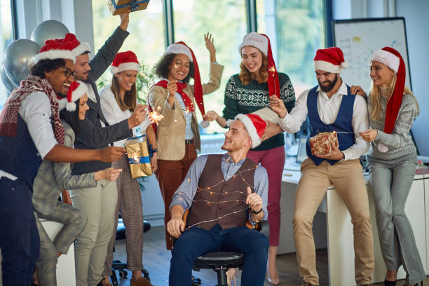 istock business people celebrating winter holidays together at work. 1192281299