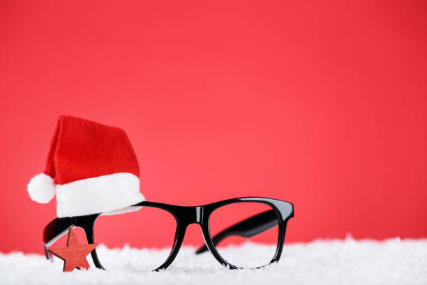 Santa hat with eyeglasses and star on red background stock photo