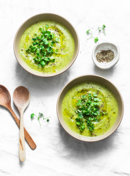 istock Mashed broccoli soup served with micro greens on a light background, top view. Healthy vegetarian food concept 1192281500