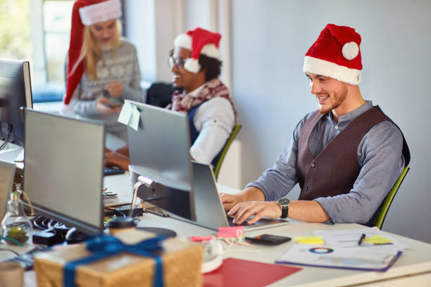 istock Young businessman working at a computer at Christmas  at office. 1192281578