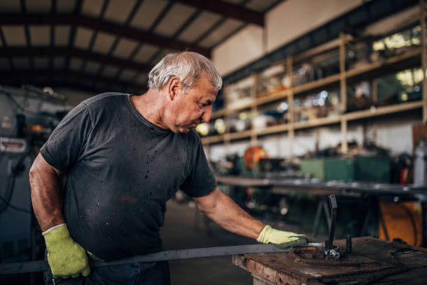 istock Mature man working in factory workshop alone 1192282737