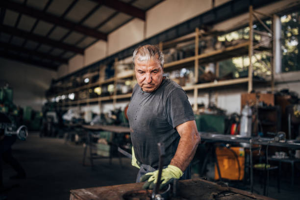 istock Mature man working in factory workshop 1192282745