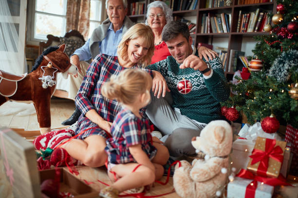 istock happy family decorates a Christmas tree 1192282966