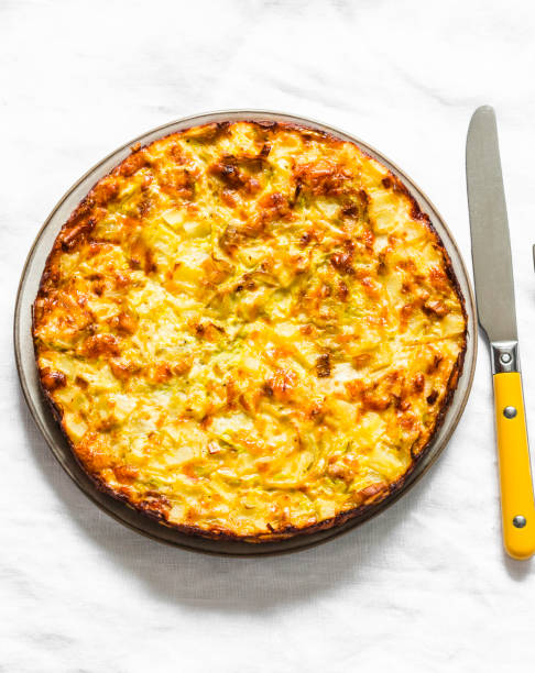 istock Leeks, potatoes, zucchini tortilla on a light background, top view. Delicious appetizer, tapas, breakfast 1192283872