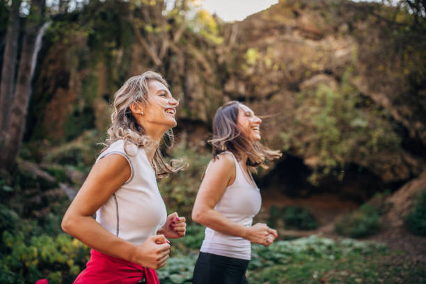 istock Two young ladies jogging in nature 1192284229