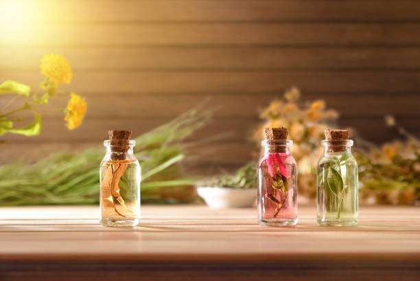 istock Jars with plant essence on table and wooden background front 1192284382