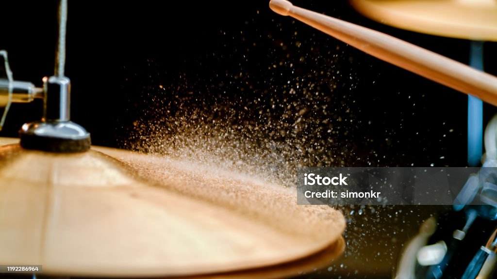 Close-up of cymbal Drumstick striking on wet cymbal. Cymbal Stock Photo