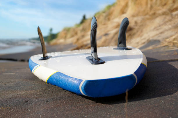 istock A blue sup board is lying on the sand close-up 1192289461