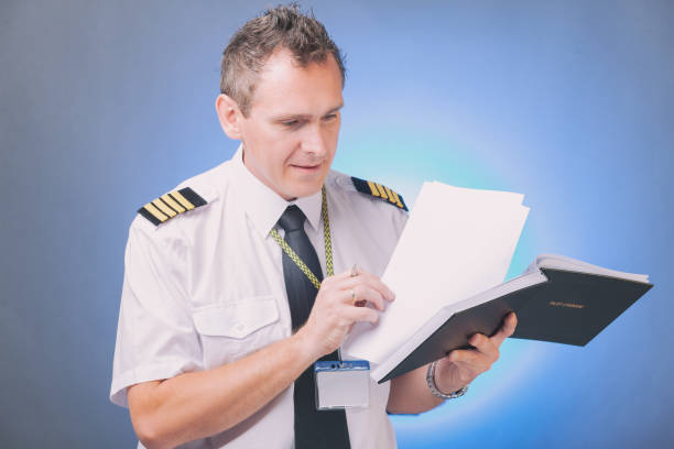 istock Pilot filling in logbook and checking papers 1192289801