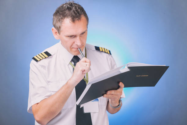 istock Pilot filling in logbook and checking papers 1192289831