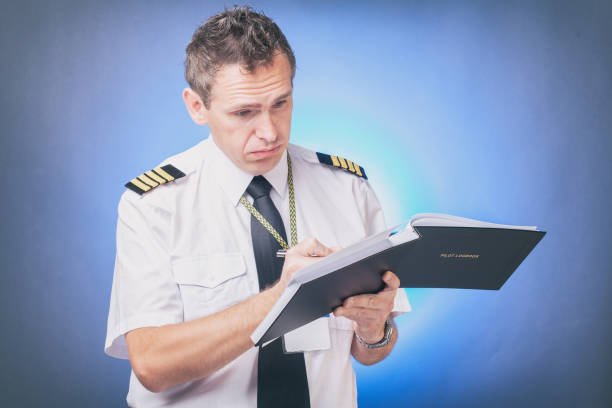 istock Pilot filling in logbook and checking papers 1192289863