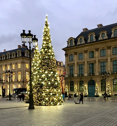 Place Vendôme during Christmas, with Christmas tree and floor lamp in Paris, France - November 29, 2019