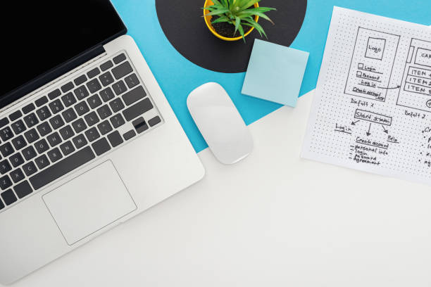 istock top view of laptop, computer mouse, plant, website design template on abstract geometric background 1192291216