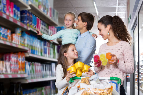 istock Parents with two kids buying fruit yoghurt 1192292063