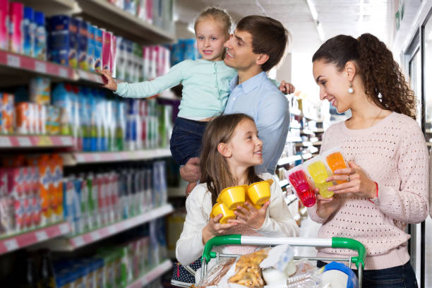 istock Parents with two kids buying fruit yoghurt 1192292087