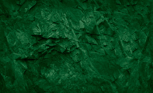 Green abstract grunge background. Green stone background. Toned rock texture.