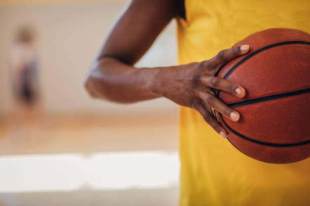 istock Black lady holding a basketball ball 1192295043