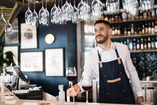 istock Bartender offering a glass of wine 1192295046
