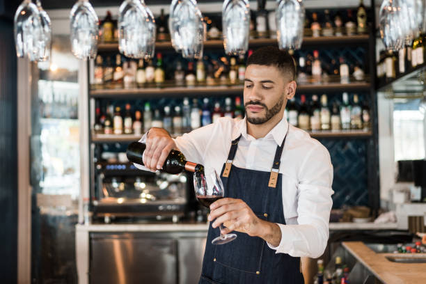 istock Bartender pouring wine in a glass 1192295779