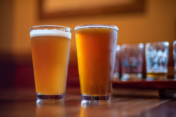 istock two pints of cold hazy ipa craft beer on table at microbrewery at night 1192295933