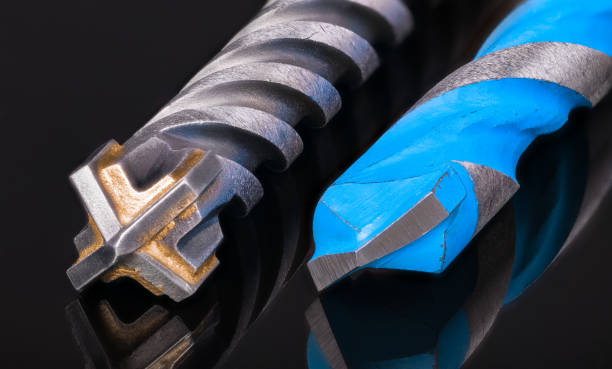istock Drill bits cutting tips detail. Artistic still life with reflection on a black background 1192298528