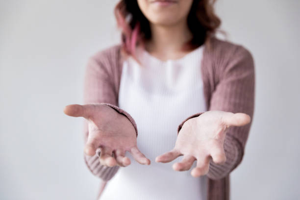 istock One unrecognizable woman holding out both hands 1192298848