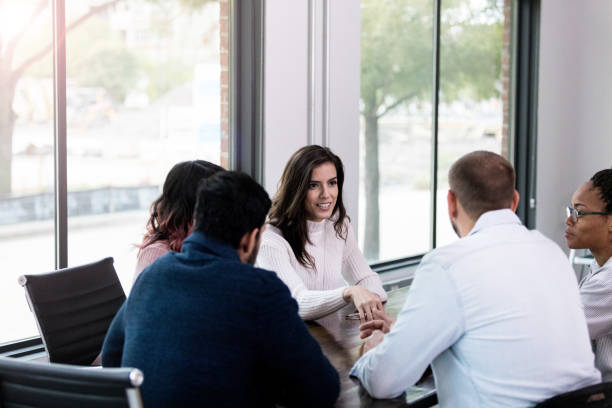 istock Multi-ethnic group of employees meet in conference room 1192298867