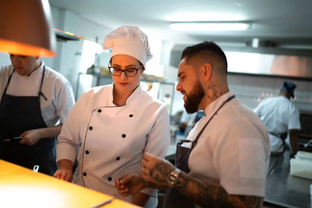 istock Chefs working together and preparing a dish at restaurant 1192299796