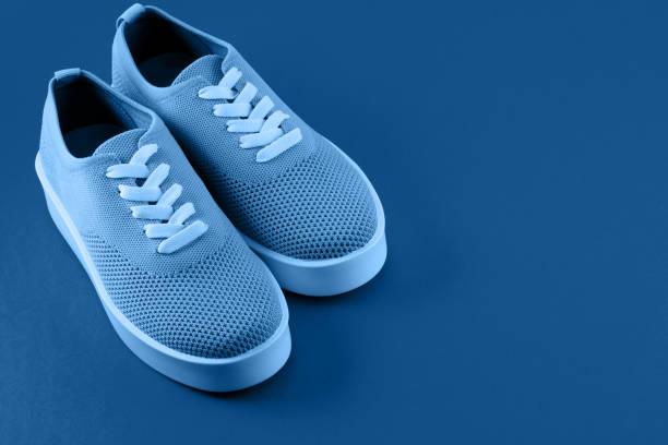 istock Bright orange sneakers on an orange background. 1192300000