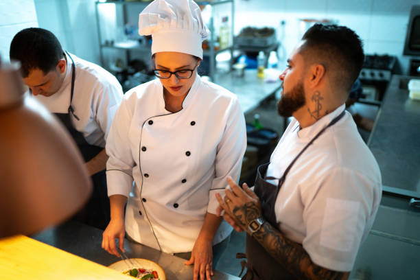istock Chefs working together and preparing a dish at restaurant 1192300072