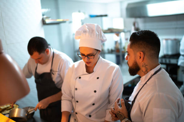 istock Chefs working together and preparing a dish at restaurant 1192300160