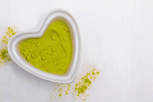 istock Dry green powdered tea matcha in heart shaped bowl 1192300442