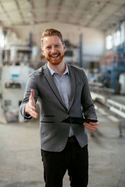 istock Businessman in factory. Engineer in production 1192302764