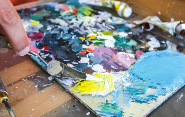 istock Real work studio of the painter. Man is creating picture. Artist concept. Creative atmosphere. Paint palette. 1192303209