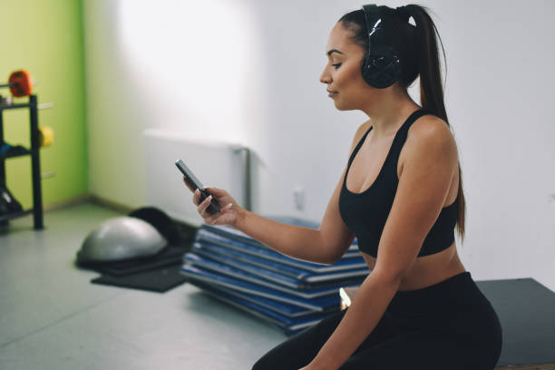 istock Sweaty athletic woman using cell phone 1192304896