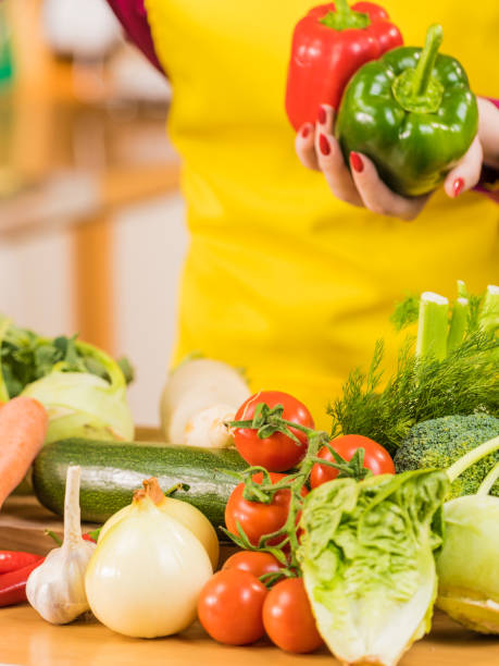 istock Woman picking bell pepper from vegetables 1192304906