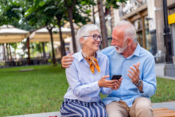 istock Senior Couple is Sitting in the Public Park and Talking 1192306607