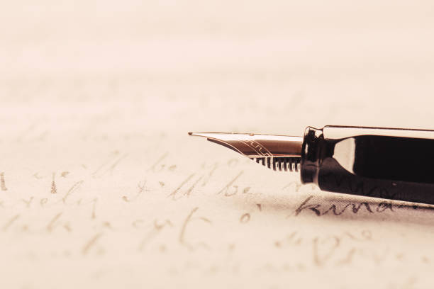 istock fountain pen on paper with ink text closeup 1192307116
