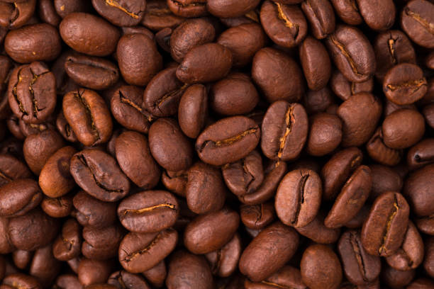 istock fresh Roasted coffee beans closeup. Background textured 1192307148