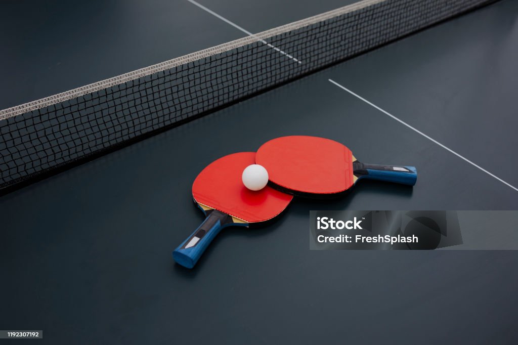 Table Tennis Equipment Red rackets and ping pong ball for table tennis. Table Tennis Stock Photo