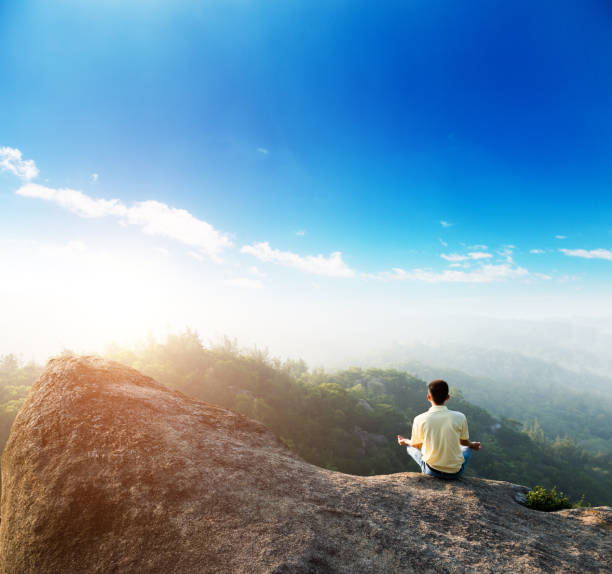 istock Meditation on the top of mountain 1192308096