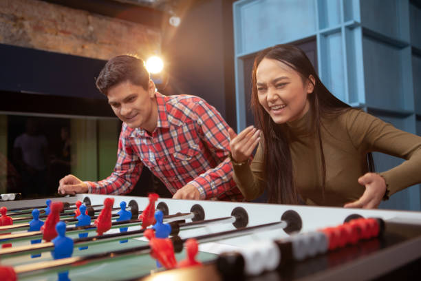 istock Couple playing foosball 1192308195