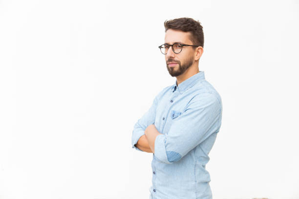 istock Serious suspicious guy with arms crossed looking at camera 1192308226