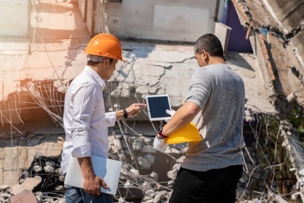 istock Demolition control supervisor and foreman discussing on demolish building. 1192309744