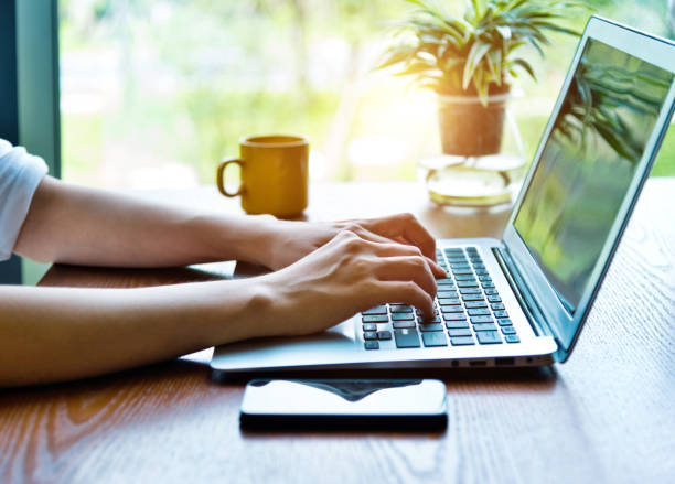 istock Woman hand typing on a laptop in restaurant 1192310508